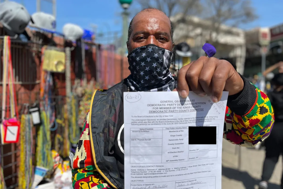picture of black man holding up a petition